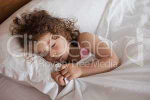 Close-up of a cute girl sleeping in bed