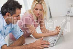 Side view of a couple using laptop