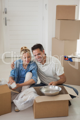 Couple sitting with boxes in new house