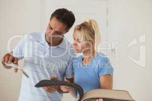 Couple looking at color book in new house