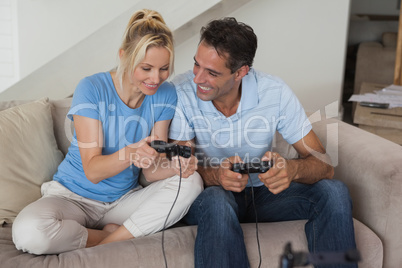 Couple playing video games in living room