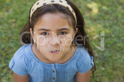 Portrait of a girl making faces at park