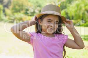 Young happy girl wearing hat in park