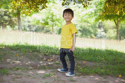 Full length portrait of a happy boy at park