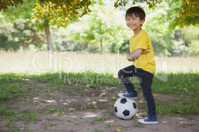 Cute little boy with football at park