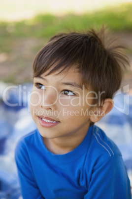 Boy looking away in thought at park