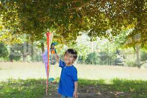 Happy young boy holding kite at park