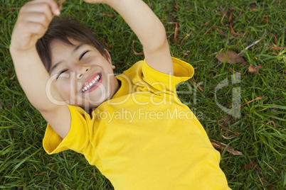 Young boy lying on grass at park