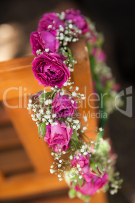 Flower wreath on a wooden bench at park