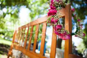 Flower wreath on a wooden bench at park