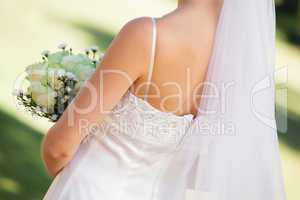 Mid section of a young beautiful bride with bouquet