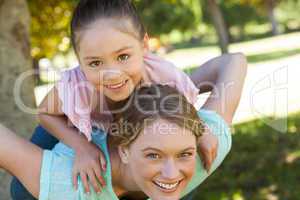 Happy mother and daughter at park