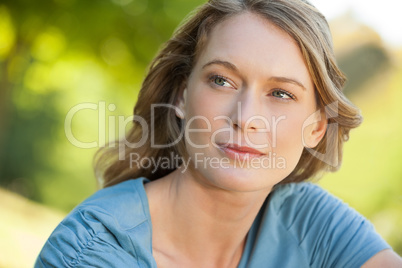 Close-up of thoughtful woman looking away in park