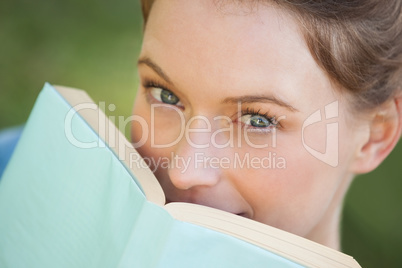 Extreme close-up portrait of beautiful woman with book