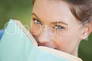 Extreme close-up portrait of beautiful woman with book