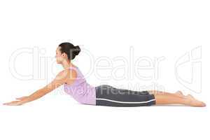 Side view of a fit young woman doing the cobra pose