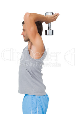 Side view of a fit man exercising with dumbbell