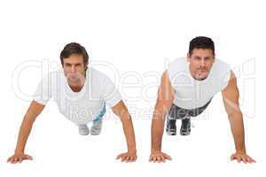 Portrait of two young men doing push ups