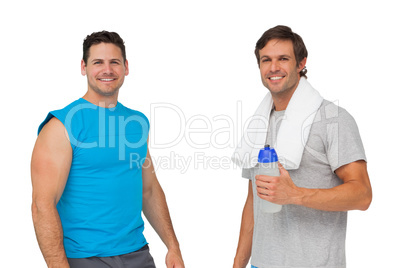 Portrait of two fit men with water bottle and towel