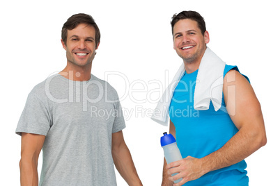 Portrait of two fit young men with water bottle and towel