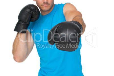 Close-up of a determined male boxer focused on training