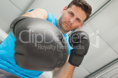 Determined male boxer focused on training