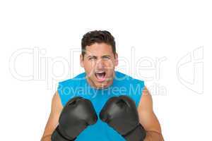 Close-up portrait of a determined male boxer screaming