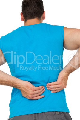 Rear view of man in sportswear suffering from backache