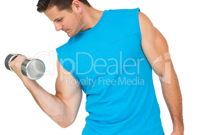 Fit young man exercising with dumbbell