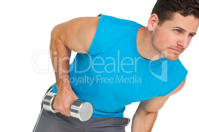 Fit young man exercising with dumbbell