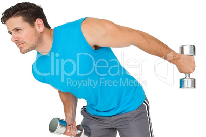 Fit young man exercising with dumbbells