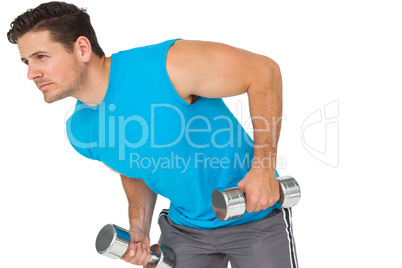 Fit young man exercising with dumbbells