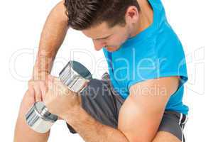 Close-up of a fit man exercising with dumbbell
