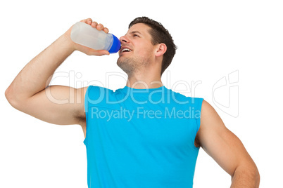 Smiling young man drinking water