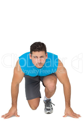 Portrait of a young sporty man in running stance