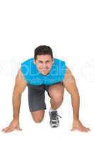 Portrait of a sporty smiling man in running stance