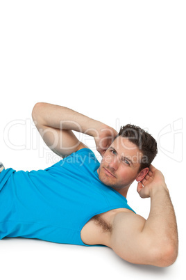 Side view portrait of a young man doing abdominal crunches