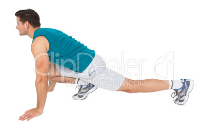 Side view of a fit man doing stretching exercise