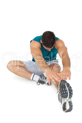 Full length of a fit young man doing stretching exercise