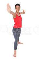 Full length of a sporty young woman stretching hands