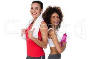 Fit young women standing with waterbottle and towel
