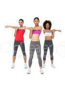 Three sporty young women stretching hands