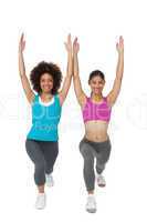 Full length of women doing power fitness exercise
