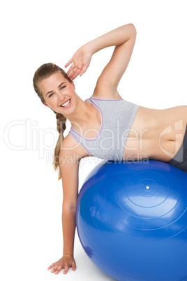 Portrait of a fit woman stretching on fitness ball