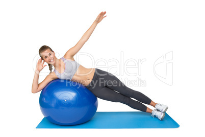 Portrait of a fit woman stretching on fitness ball