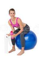 Portrait of a fit woman sitting on exercise ball