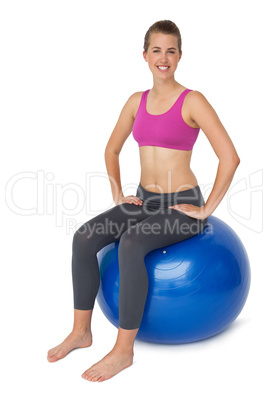 Portrait of a fit woman sitting on exercise ball