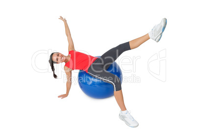 Fit young woman stretching on exercise ball