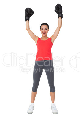 Portrait of a cheerful female boxer raising hands