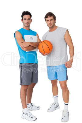 Two fit young men with scales and basketball